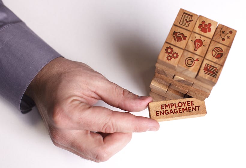 Man holding Employee Engagement building block
