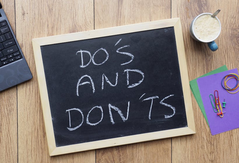 Do's and don'ts written on a chalkboard at the office.