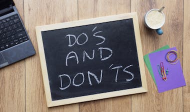 Do's and don'ts written on a chalkboard at the office.
