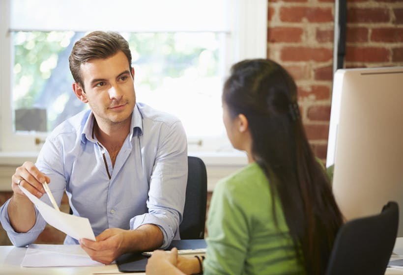 Businessman interviewing female job applicant in office