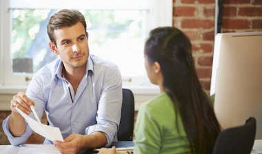 Businessman interviewing female job applicant in office