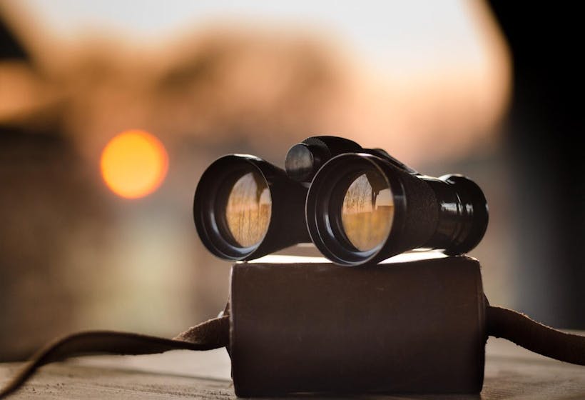 Header image of black binocular for article on visibility of remote teams