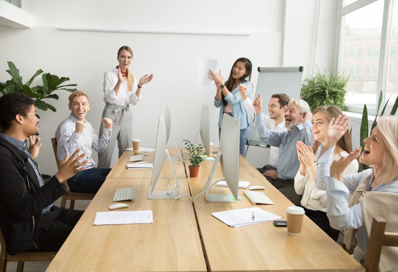 People in a meeting clapping hands.