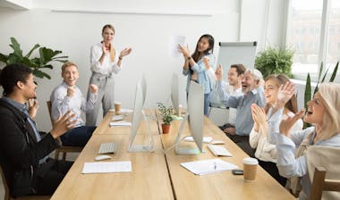 People in a meeting clapping hands.