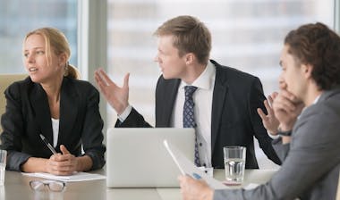 Furious boss scolding young frustrated interns.