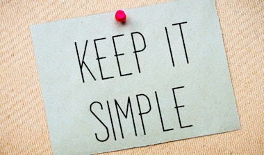 Post-it on a carton board with the words 'Keep it simple'.