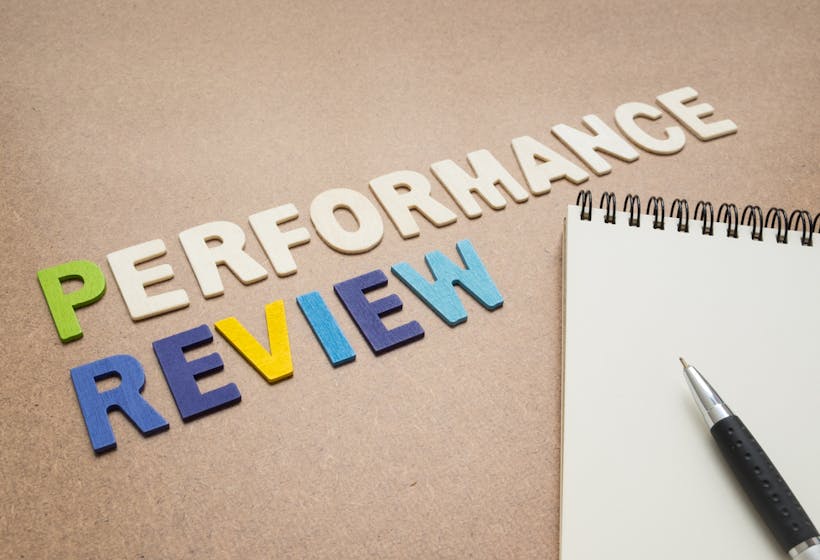 Performance reviews letters on an office desk.